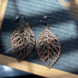 A pair of earrings that look like leaves